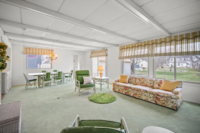 sunroom featuring a chandelier and beamed ceiling