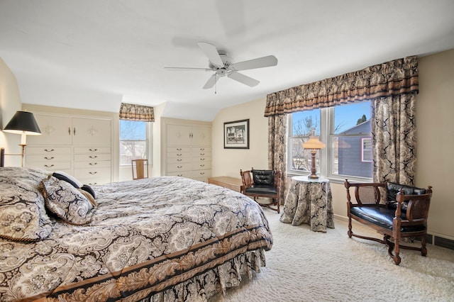 carpeted bedroom with multiple windows, ceiling fan, vaulted ceiling, and baseboards