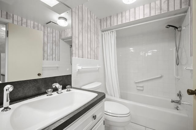 bathroom with wallpapered walls, toilet, shower / bath combo with shower curtain, tile walls, and vanity