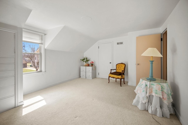 sitting room featuring carpet and lofted ceiling