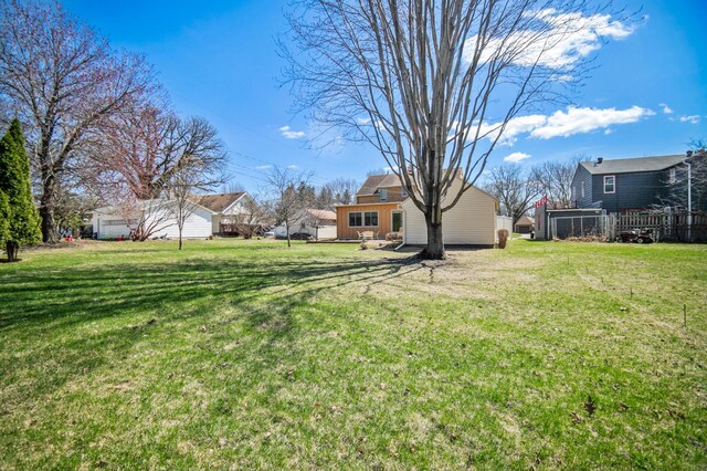 240 S St S, Owatonna, MN 55060 - view of grassy yard featuring a residential view and a garage