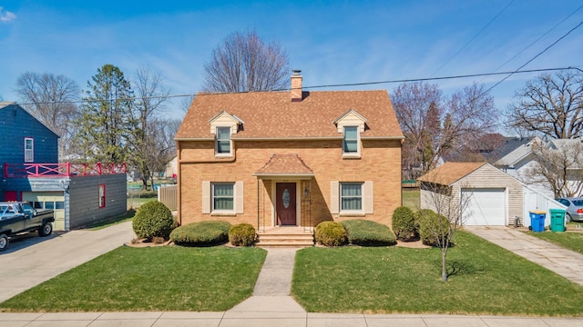 traditional home with driveway, brick siding, a garage, a chimney, and an outdoor structure