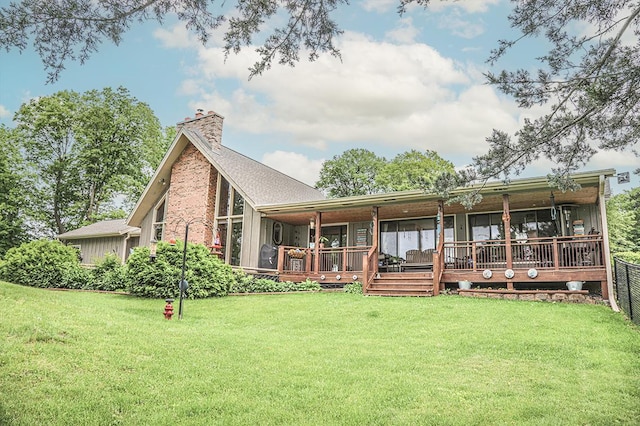 back of property featuring a chimney and a yard