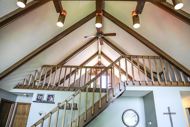 interior space with high vaulted ceiling, beam ceiling, and ceiling fan
