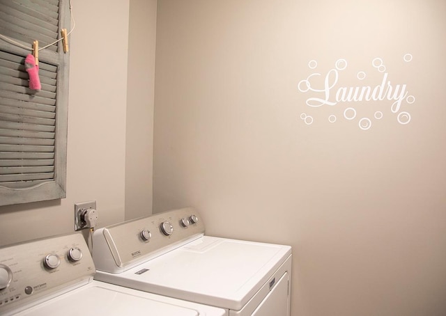 clothes washing area featuring washer and dryer and laundry area