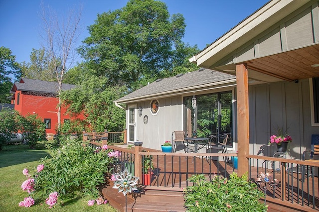 wooden terrace with a lawn