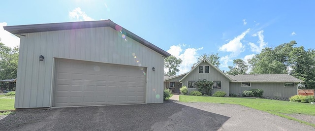 exterior space with a garage and a front lawn