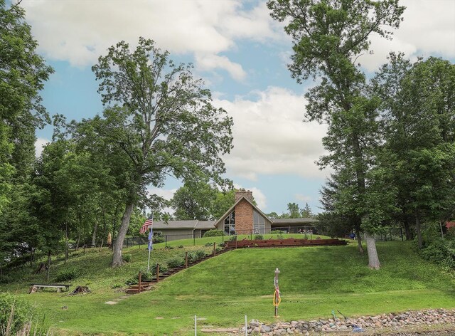 view of front of house featuring a chimney and a front yard