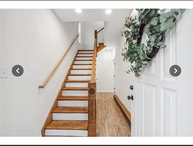 stairs with wood finished floors, baseboards, and recessed lighting