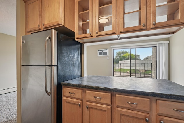 4110 Rahn Rd Unit 124, Eagan, MN 55122 - kitchen with freestanding refrigerator, dark countertops, glass insert cabinets, a baseboard heating unit, and brown cabinets