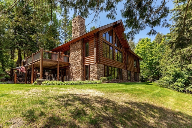 31690 Large Pine Trl, Laporte, MN 56461 - rear view of house with stone siding, a chimney, a yard, stairs, and a deck