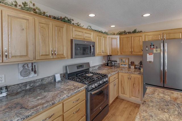 31690 Large Pine Trl, Laporte, MN 56461 - kitchen with appliances with stainless steel finishes, light wood-style floors, recessed lighting, a textured ceiling, and light stone countertops