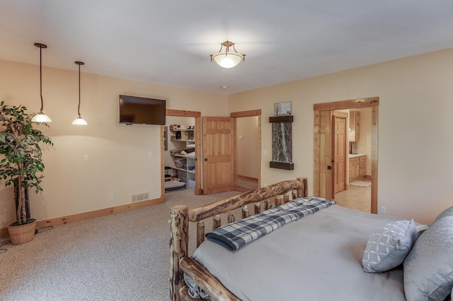 31690 Large Pine Trl, Laporte, MN 56461 - carpeted bedroom featuring baseboards, a spacious closet, and ensuite bath