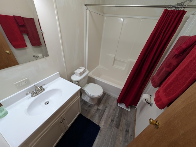 bathroom with shower / tub combo, vanity, toilet, and wood finished floors