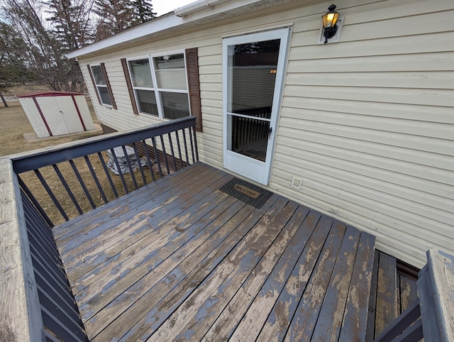 deck with a storage shed and an outdoor structure