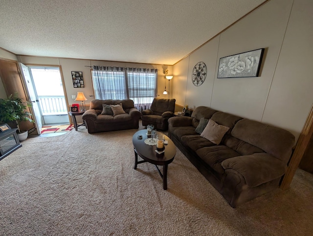 living area with carpet flooring, lofted ceiling, and a textured ceiling