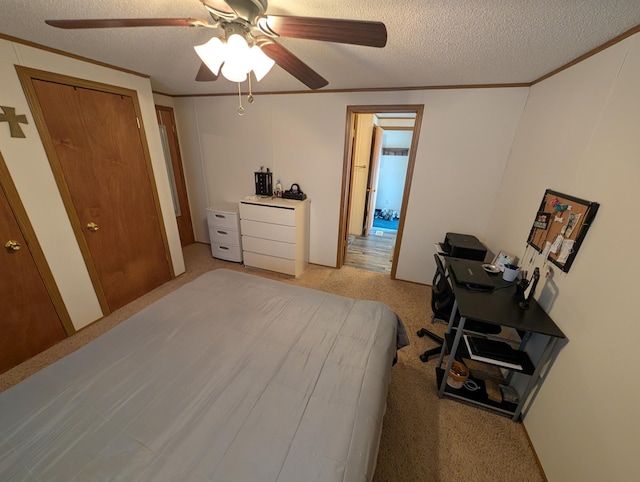 bedroom featuring ceiling fan, a textured ceiling, light colored carpet, and crown molding