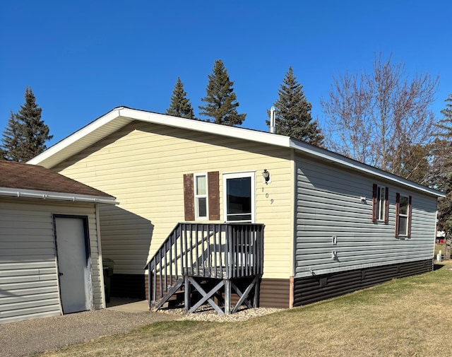 back of property with a lawn