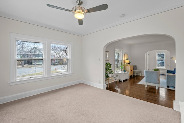4001 Sheridan Ave S, Minneapolis, MN 55410 - unfurnished room featuring arched walkways, carpet, baseboards, a ceiling fan, and ornamental molding