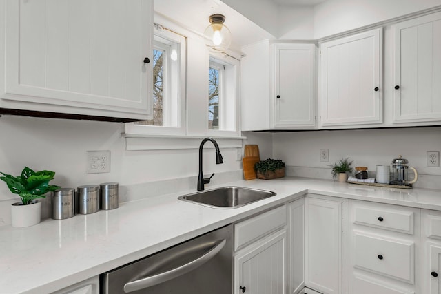 4001 Sheridan Ave S, Minneapolis, MN 55410 - kitchen featuring stainless steel dishwasher, a sink, light countertops, and white cabinets