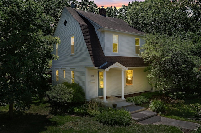 4001 Sheridan Ave S, Minneapolis, MN 55410 - dutch colonial featuring a chimney, a gambrel roof, and a shingled roof
