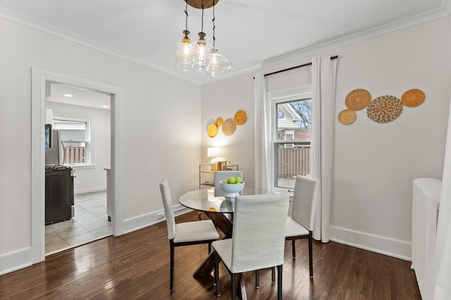4001 Sheridan Ave S, Minneapolis, MN 55410 - dining space featuring ornamental molding, wood finished floors, radiator heating unit, and baseboards