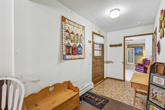 hallway featuring baseboard heating and a textured ceiling