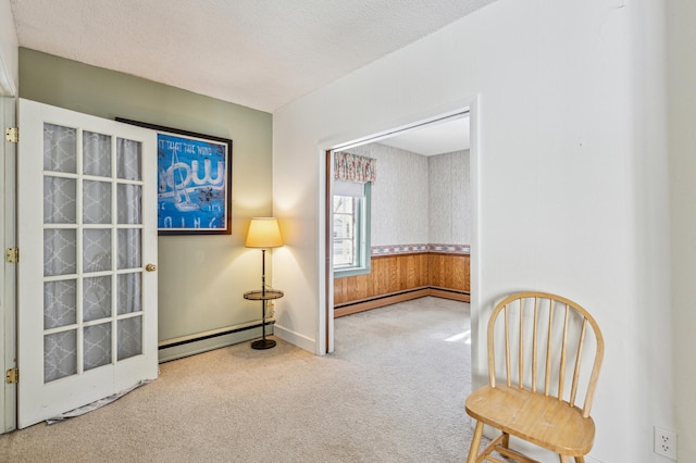 unfurnished room featuring carpet floors, baseboards, and a baseboard heating unit