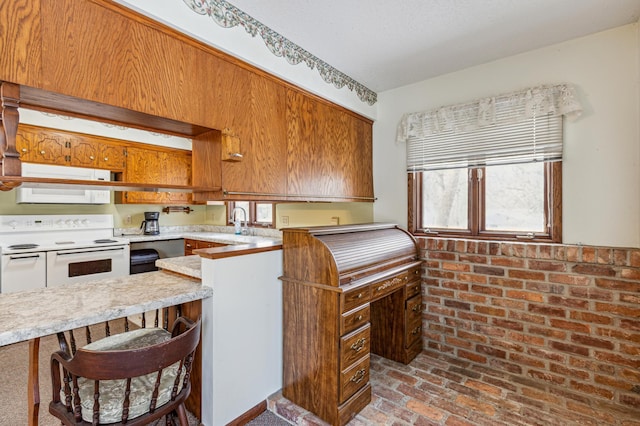 kitchen featuring light countertops, brick floor, white appliances, and brown cabinetry