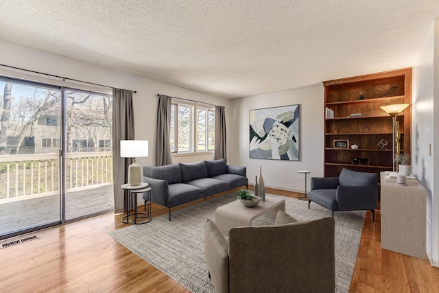 living area featuring a textured ceiling and wood finished floors