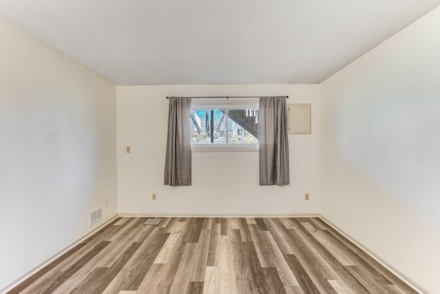 empty room with wood finished floors and baseboards