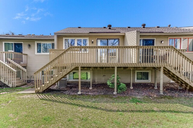 rear view of property with stairs, central AC unit, a lawn, and a wooden deck