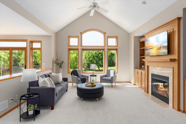 15210 Painters Lane Cir N, West Lakeland Twp, MN 55082 - carpeted living area featuring healthy amount of natural light, a fireplace, ceiling fan, baseboards, and high vaulted ceiling