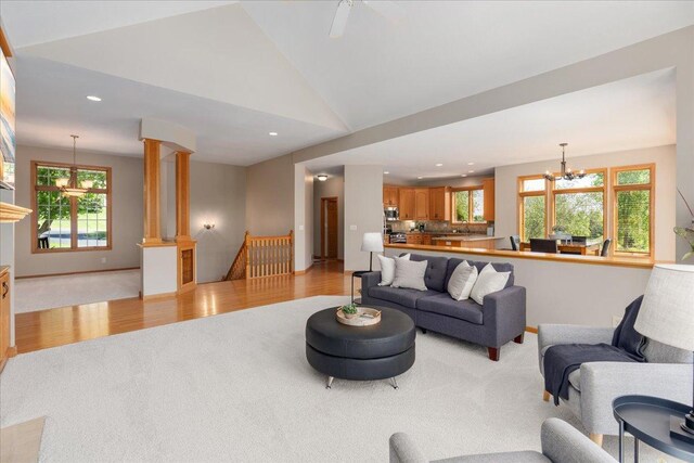 15210 Painters Lane Cir N, West Lakeland Twp, MN 55082 - living room with light colored carpet, vaulted ceiling, a chandelier, light wood-type flooring, and recessed lighting