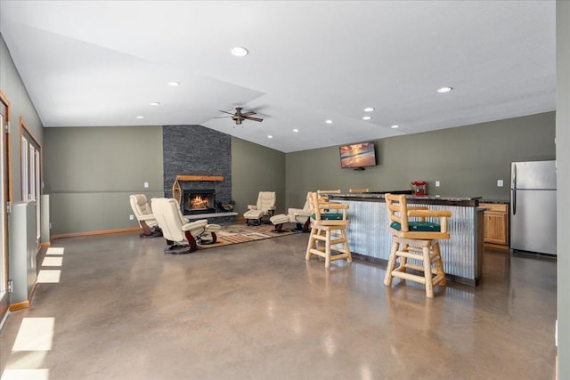 15210 Painters Lane Cir N, West Lakeland Twp, MN 55082 - living area featuring a bar, a ceiling fan, a fireplace, concrete floors, and vaulted ceiling