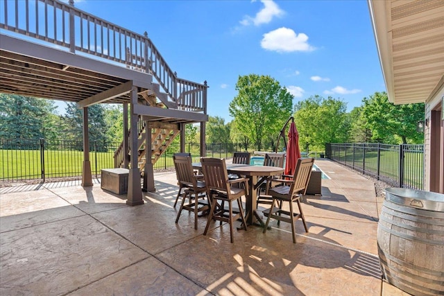 15210 Painters Lane Cir N, West Lakeland Twp, MN 55082 - view of patio / terrace with stairway, outdoor dining area, a deck, and view of wooded area