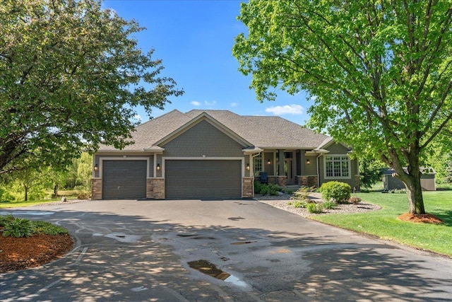 15210 Painters Lane Cir N, West Lakeland Twp, MN 55082 - craftsman inspired home featuring asphalt driveway, an attached garage, stone siding, and a front lawn