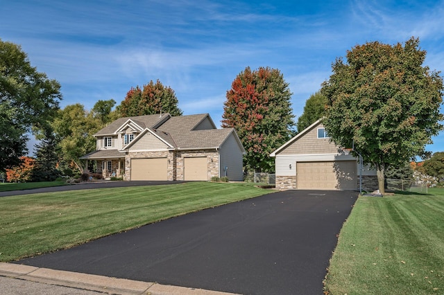 craftsman-style home with a front yard and stone siding