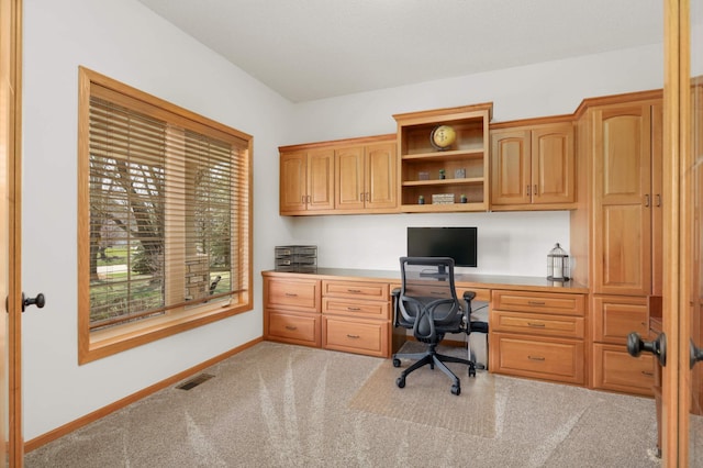 office area with built in desk, visible vents, carpet, and baseboards