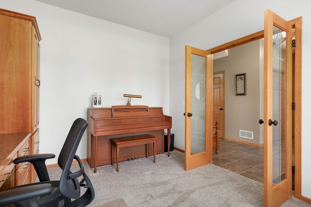 carpeted home office with visible vents, french doors, and baseboards