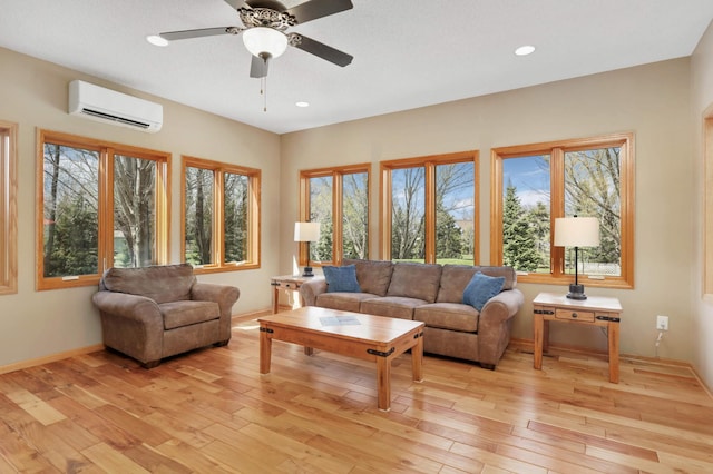 living area with recessed lighting, a wall unit AC, light wood-style floors, and a healthy amount of sunlight