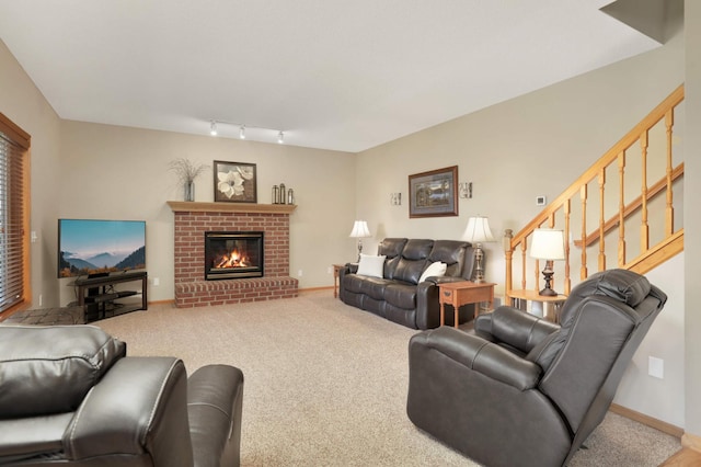 living room with carpet floors, stairway, baseboards, and a brick fireplace