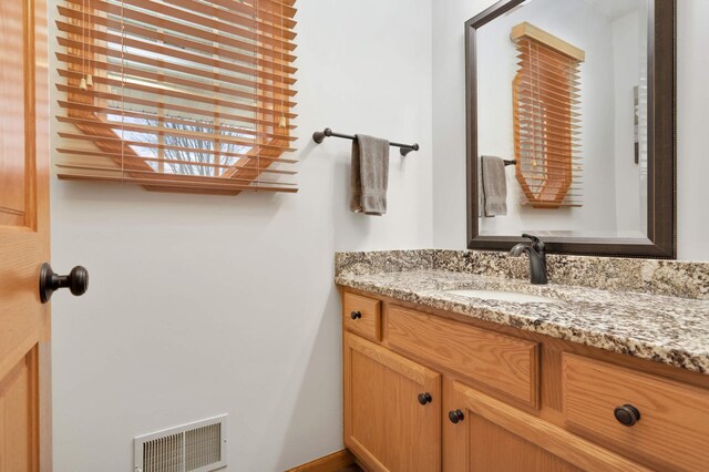 bathroom with visible vents and vanity