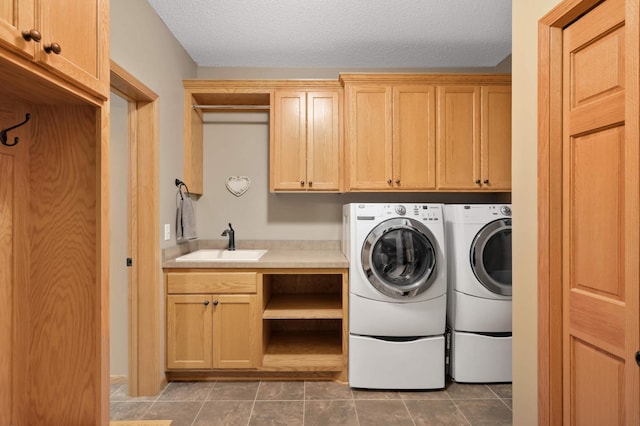 washroom with tile patterned flooring, independent washer and dryer, a sink, and cabinet space