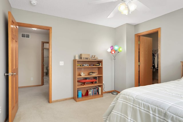 bedroom featuring baseboards, visible vents, a ceiling fan, and light carpet