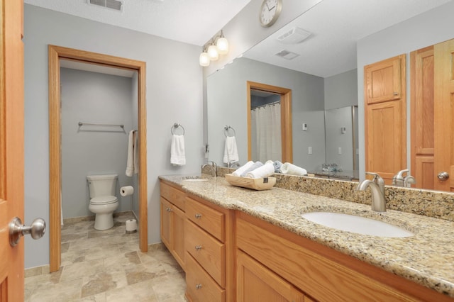 full bathroom with double vanity, visible vents, toilet, and a sink
