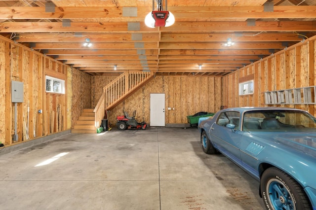 garage with electric panel and a garage door opener