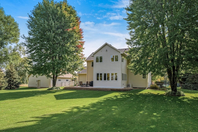 back of property with fence and a yard