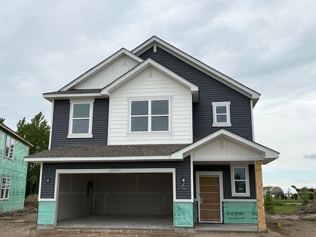 10037 73rd Ln NE, Otsego, MN 55330 - view of front of house with an attached garage, a shingled roof, and board and batten siding