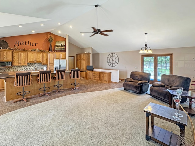 living area featuring high vaulted ceiling, a ceiling fan, and recessed lighting